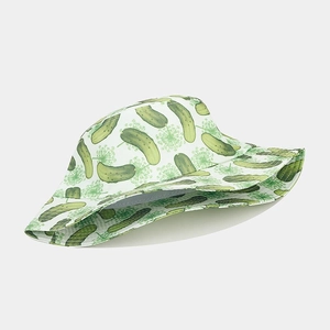 Close-up of white bucket hat featuring green cucumber and floral patterns with fine stitching