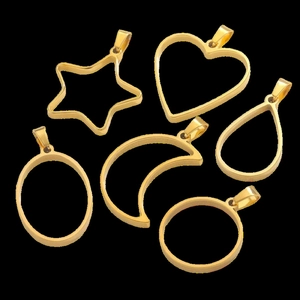 Close-up of golden stainless steel hollow frames in star heart and moon shapes for DIY jewelry