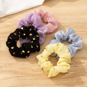 Set of 5 floral chiffon scrunchies with gold heart patterns on a wooden surface