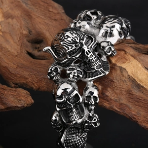Macro shot of gothic skull bracelet in polished stainless steel on weathered wood