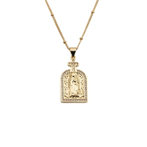 Detail of gold virgin mary pendant necklace with sparkling zircon accents on white background