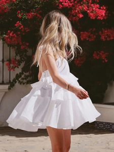 Detail of white tiered ruffle hem and open back design on a summer sundress