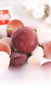 Macro shot of flocked Christmas balls set featuring velvet texture and geometric patterns