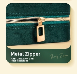 Close-up of a sturdy gold metal zipper and soft velvet texture on a green jewelry case