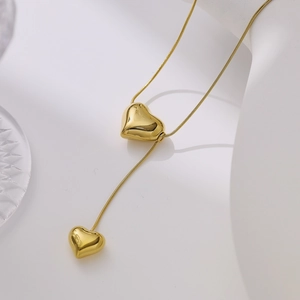 Detail of gold-plated double heart pendant necklace on a professional jewelry display
