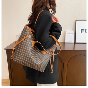 Detail of the vintage tote bag showing geometric print and side drawstring on model