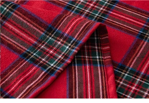 Detail of red plaid table runner fabric with festive tartan pattern and quality stitching