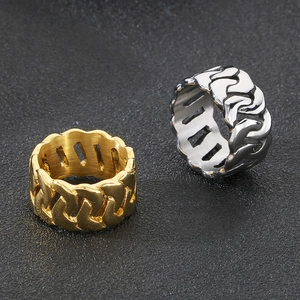 Polished 18k gold and silver stainless steel cuban chain rings on dark background