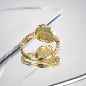 Detailed view of vintage gold ring with micro-set zircon on a mirror reflection