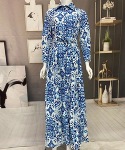 Detail of blue and white Majolica print shirt dress with lapel collar and waist belt