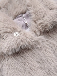 Detail of grey-purple faux fur texture with high-quality metal snap fastener closure