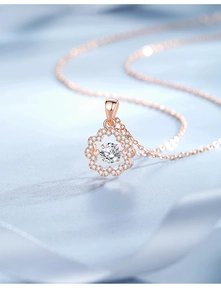 Macro shot of rose gold sunflower pendant with a sparkling center zircon and pavé petals