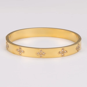 Gold stainless steel hinged bangle with clover flower charms and sparkling zircons