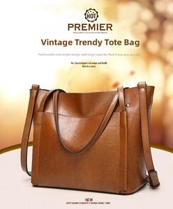 Detail of vintage brown oil wax leather tote showing V-shaped stitched front pocket design