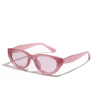 Vintage pink cat-eye sunglasses with translucent frames and metal rivet accents