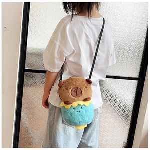 Detail of Capybara plush crossbody bag with soft texture and floral decoration