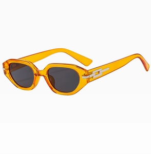 Detail of orange transparent sunglasses frame with silver geometric metal accents