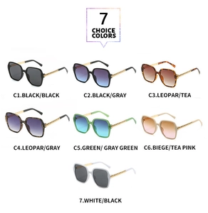 Detail of seven stylish oversized polygon sunglasses with decorative gold chain temples