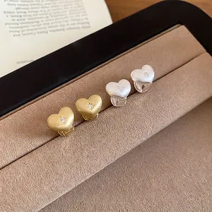 Brushed heart-shaped earrings with zircon inlay in gold and silver finish