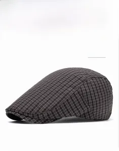 Detailed close-up showing the coffee brown plaid texture of the vintage beret flat cap