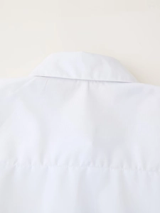 Detailed view of the back collar and stitching on a white sport-style women shirt