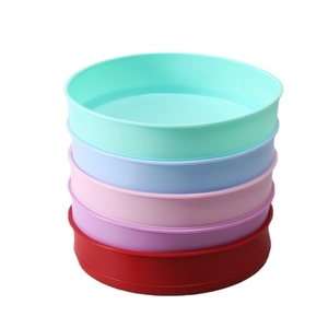 Stack of five colorful round silicone cake molds in mint green, blue, pink, purple, and red