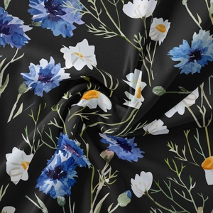 Macro shot of linen textured tapestry featuring blue cornflowers and white daisies pattern