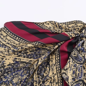 Fashionable paisley print dress with silk-like sheen in burgundy and black tones