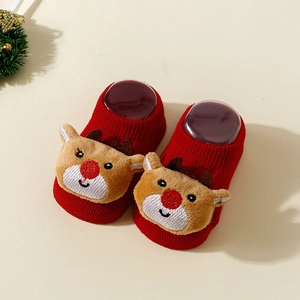 Detail of red Christmas baby socks with 3D plush reindeer and non-slip knit texture
