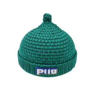 Deep green knit baby beanie with textured pattern and top pompom on white background