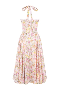 Close-up of pink floral dress featuring halter neck straps and back zipper closure detail