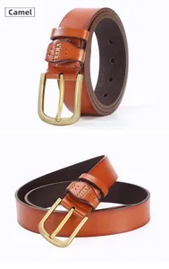 Detail of camel faux leather belt with golden pin buckle and cross stitch reinforcement