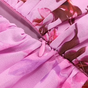Detail of hidden zipper and floral chiffon fabric on a pink summer halter dress