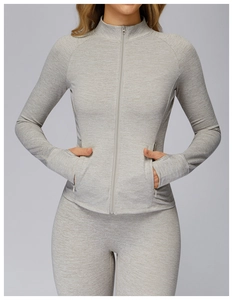 Detail view of heather grey yoga set featuring a zip-up jacket with thumbhole cuffs