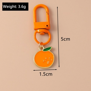 Detail view of orange enamel keychain showing dimensions 5cm x 1.5cm and 3.6g weight