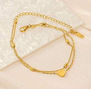 Macro shot of 18K gold plated double layer heart anklet showing lobster clasp and S.Steel tag