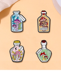 Close-up of four colorful mushroom magic potion enamel pins with assorted magic themes