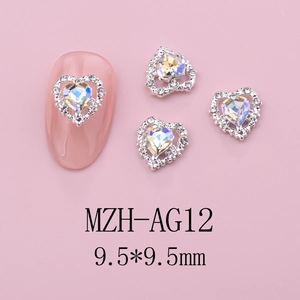 Detailed view of aurora heart nail art charm with silver alloy base and small white rhinestones