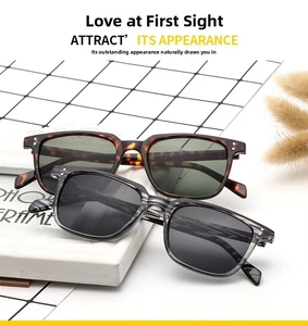 Close-up of retro square sunglasses in tortoiseshell and grey with silver metal rivets