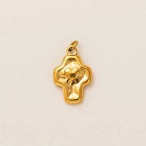 Detailed macro view of 18k gold plated cross pendant with heart and hammered texture