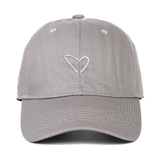 Close-up of light gray cotton baseball cap featuring white heart outline embroidery
