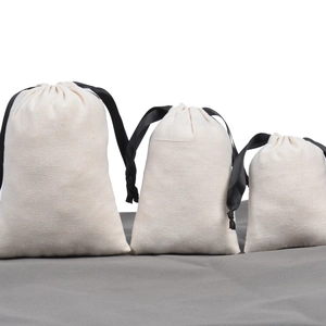Three beige cotton drawstring pouches in different sizes for jewelry packaging and storage