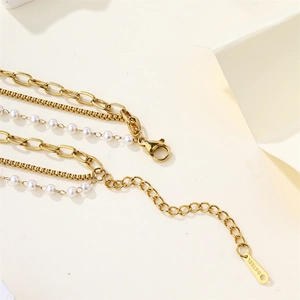 Detailed close-up of 18K gold-plated stainless steel clasp and multi-layer pearl chains