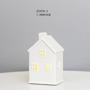 Detailed view of white ceramic house ornament with cut-out windows, size 7.3x6x12cm