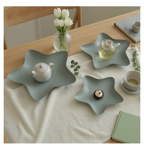 Detailed view of matte star-shaped ceramic plates in Morandi blue for home decor