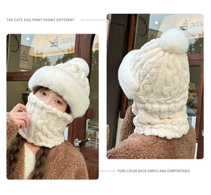 Detail of beige fleece-lined integrated hat and neck warmer with large fluffy pompom