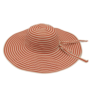 Macro view of red and white striped sun hat texture with decorative bow ribbon detail