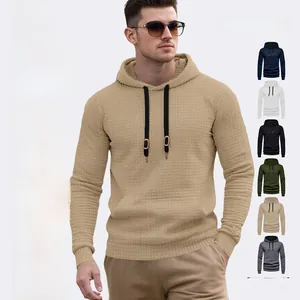 Detailed close-up of textured waffle pattern fabric on men's drawstring hoodie