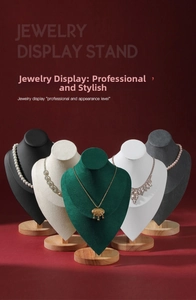 Detail of wooden necklace display busts in various colors with premium velvet finish