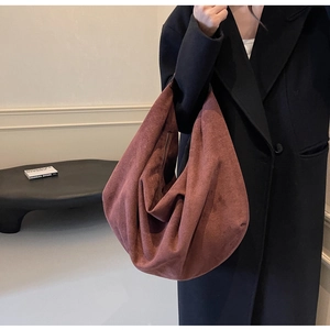 Detail of soft matte suede tote bag in brick red showing spacious interior and drape